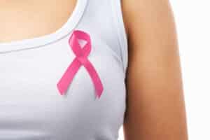 Pink badge on woman chest to support breat cancer cause